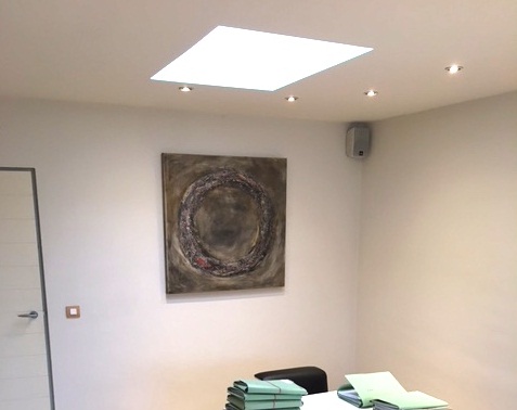 Interior design: Square textured abstract painting in neutral colors and a dash of red